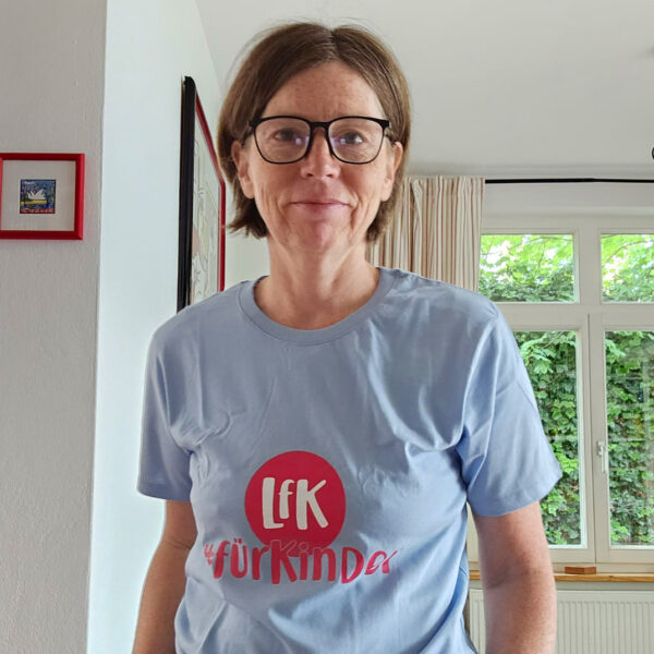 Dr. Nicole Reese mit hellblauem shirt mit der aufschrift lfk für kinder